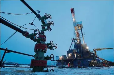  ?? — Reuters ?? Exports down: A well head and drilling rig in the Yarakta Oil Field in Russia. Analysts say the coronaviru­s will accelerate the decline in global fossil fuel use.