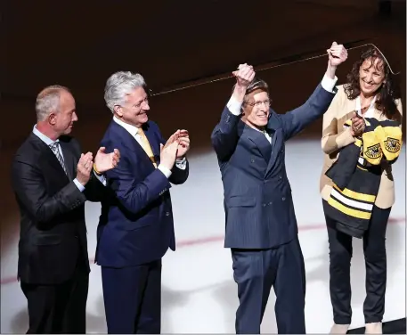  ?? STAFF PHOTO — STUART CAHILL/BOSTON HERALD ?? Prior to Tuesday’s game, NESN announcer Jack Edwards receives a gold stick from Bruins owner Charlie Jacobs after Edwards announced he is retiring from calling games.
