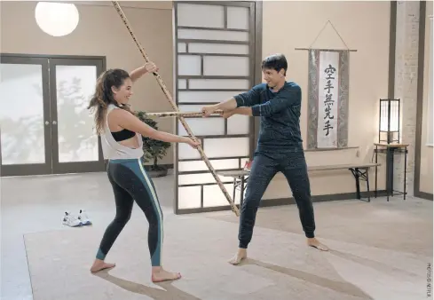  ??  ?? Mary Mouser, left, and Ralph Macchio in a scene from Season 3 of
Cobra Kai.