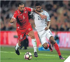  ??  ?? ■
Malta’s Steve Borg holds off England sub Marcus Rashford.