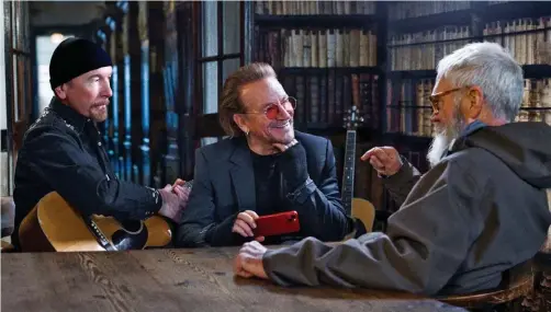  ?? ?? David Letterman, right, interviews U2 guitarist the Edge, left, and singer Bono in “A Sort of Homecoming” for Disney+.