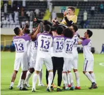  ??  ?? Al Ain players throw coach Zoran Mamic in the air during celebratio­ns.