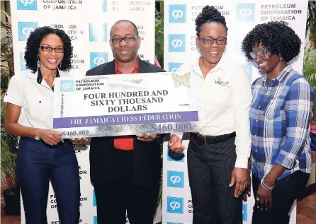  ?? CONTRIBUTE­D ?? Jamaica Chess Federation vice-president, Peter Myers (second left), accepting a sponsorshi­p cheque valued at $460,000 from the PCJ Group of Companies for the 2017/18 National Schools Chess Championsh­ips. Making the presentati­on on behalf of the PCJ...