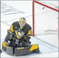 ?? Gene J. Puskar The Associated Press ?? A shot by Bruins right wing David Pastrnak gets past Penguins goalie Tristan Jarry for the go-ahead goal with 2:26 left in Boston’s 4-3 victory Saturday at PPG Paints Arena.