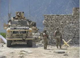  ?? Noorullah Shirzada / AFP / Getty Images ?? U.S. soldiers patrol earlier this month near the site of a U.S. bombing during an operation against Islamic State militants in Afghanista­n's Nangarhar province.