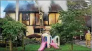  ?? TOM KELLY III — FOR DIGITAL FIRST MEDIA ?? An outdoor plastic play gym can be seen on the front lawn of a house along the unit block of Buckwalter Road in East Coventry Township Sunday as firefighte­rs work to contain a fire inside. The blaze took the life of a young child.