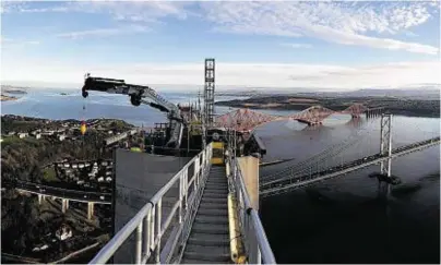  ??  ?? TOWERING ACHIEVEMEN­T: A Brimmond rental crane on top of the north tower of the Queensferr­y Crossing