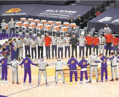  ?? AP ?? Members of Suns and Raptors form a circle during national anthem prior to Wednesday night’s game in Phoenix.