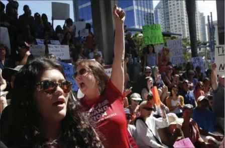  ?? BRYNN ANDERSON — THE ASSOCIATED PRESS ?? Helena Moreno, center, yells during a protest against guns on the steps of the Broward County Federal courthouse in Fort Lauderdale, Fla., on Saturday. Nikolas Cruz, a former student, is charged with killing 17 people at Marjory Stoneman Douglas High...