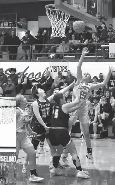  ?? Barb Miller ?? Shown above, Anselmo-Merna freshman Shayleigh Coleman (15) shoots over Twin Loup’s Miranda Olson (15) and Madison Glidden (30). Shayleigh had 2 points, 5 rebounds and a steal in the Lady Coyotes 42-37 win over the Lady Wolves.