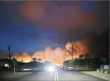  ?? ROD ANTONE photo ?? PHOTO LEFT: A fire that started in Haliimaile glows in the distance on Wednesday night, as seen from Skill Village. Residents were advised to prepare for possible evacuation but were able to stay in their homes.