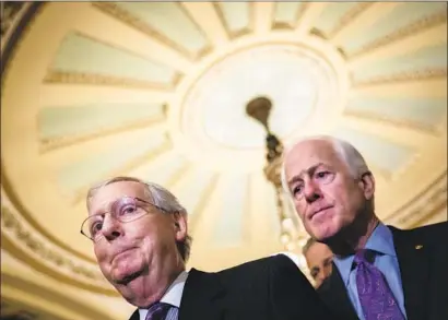  ?? Drew Angerer Getty Images ?? SENS. Mitch McConnell and John Cornyn address reporters after Christine Blasey Ford agreed to testify in the Senate.