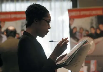  ?? LYNNE SLADKY — THE ASSOCIATED PRESS ?? Joana Dudley of Lauderhill, Fla., looks at her list of job prospects at a JobNewsUSA job fair in Miami Lakes, Fla.