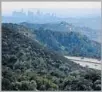  ??  ?? FROM ON HIGH, hikers on the Descanso Trail in La Cañada Flintridge can see downtown L.A., left. Bikers take the trail too. Afternoons, the path is largely shaded, a blessing in sunny SoCal.