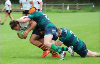  ??  ?? It takes two Ballina players to stop Sligo’s Sean Mullin during the side’s Connacht Senior League game.