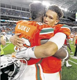  ?? AL DIAZ / MIAMI HERALD ?? Miami tight end David Njoku gets a hug from his quarterbac­k, Brad Kaaya, after the Hurricanes defeated Duke last month. The players are the subject of much speculatio­n about their future with the Hurricanes.