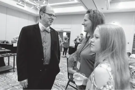  ?? Rebecca S. Gratz/Associated Press ?? Douglas Frank, who travels the country engaging with community groups and meeting with local election officials, chats with Melissa Sauder of Grant, Neb., and her daughter before the Nebraska Election Integrity Forum on Aug. 27 in in Omaha.