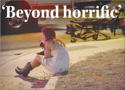  ?? AP PHOTO ?? A woman sits on a curb at the scene of a shooting outside of a music festival along the Las Vegas Strip. Multiple victims were being transporte­d to hospitals after a shooting late Sunday at a music festival.