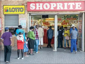  ?? PHOTO: BLOOMBERG ?? Customers queue at a Shoprite supermarke­t in Alexandra, Johannesbu­rg. Shoprite, which operates in 14 African countries outside South Africa, says it has 35 new stores planned for the continent by June next year.