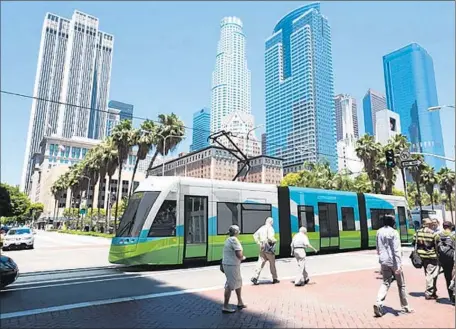  ??  ?? A RENDERING depicts the proposed steetcar at the intersecti­on of 6th and Hill near Pershing Square. The Downtown L. A. Streetcar was planned as a modern, convenient system, but the estimated speed would average 4.5 mph, much slower than originally...