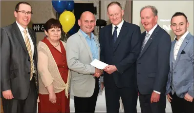  ?? Photo by Michelle Cooper Galvin. ?? Mike Coffey of the Two Mikes (third from left) presenting the €800 proceeds of the Beaufort CD ‘Lios a’ Phuca Abú’ to Chairperso­n Frank Coffey. From left: Treasurer Padraig O’Sullivan, Secretary Bridget Hartnett, composer Neilie O’Sullivan, and Paudie Coffey.