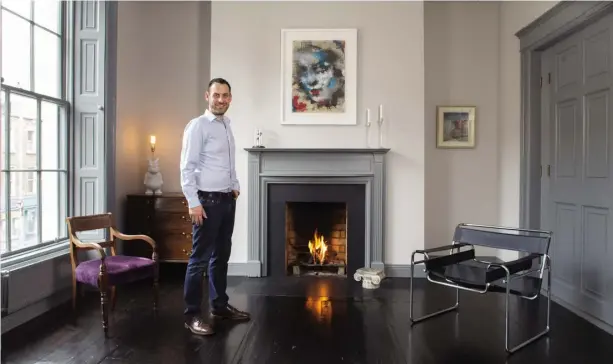  ??  ?? ABOVE: Colm Doyle in one of the four formal reception rooms. This is one of only two rooms where the original floors are used. All the original sash windows were restored. The painting over the mantlepiec­e is by Katarzyna Gajewska this magnificie­nt...