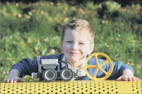  ??  ?? WINNING IDEA: Lucas Dawson with the Plug n Plough ‘tractor of the future’ designed by pupils from Settle Church of England Primary School.