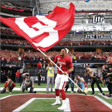 ?? [BRYAN TERRY/THE OKLAHOMAN] ?? If the Sooners can upset LSU on Saturday, quarterbac­k Jalen Hurts might channel his inner-Baker Mayfield again by waving the OU flag as he did after beating Baylor in the Big 12 title game.