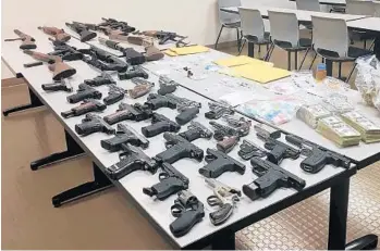  ?? BROWARD SHERIFF’S OFFICE/COURTESY PHOTOS ?? Among the items confiscate­d after a raid at a Pompano Beach home and a storage unit were 11 rifles and 28 handguns. Scott Fernandez, 46, was arrested on drug charges . He was not charged with any weapons offenses.