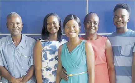  ??  ?? The Scott family joins in a photo opportunit­y following the oath ceremony for Dr Kimberley Scott (foreground at The University of the West Indies, Mona, in 2019. From left are proud dad, Rupert Scott, sibling Makeda Scott, mom Thelma Scott, and brother Rupert J Scott.