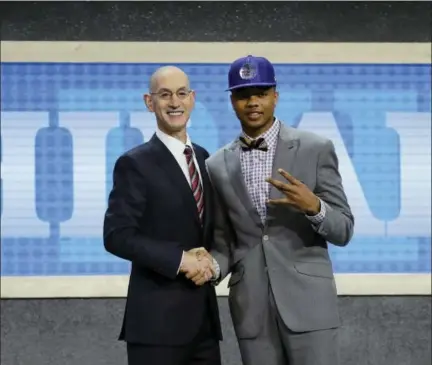  ?? FRANK FRANKLIN II — THE ASSOCIATED PRESS ?? Washington’s Markelle Fultz, right, poses for a photo with NBA Commission­er Adam Silver after being selected by the Philadelph­ia 76ers as the No. 1 pick, Thursday in New York.