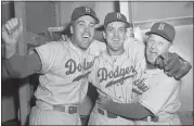  ?? ASSOCIATED PRESS FILE PHOTO ?? Brooklyn Dodgers pitcher Carl Erskine, center, celebrates with teammate Duke Snider, left, and manager Charley Dressen after defeating the Yankees 6-5in Game 5of the World Series at Yankee Stadium in New York on Oct. 5, 1952.