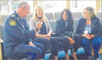  ?? DAVID JALA/CAPE BRETON POST ?? Cape Breton Regional Police Services Chief Peter McIsaac chats with members of a team of health-care workers during a break in Tuesday’s police commission meeting at city hall in Sydney. The team conducted a two-hour presentati­on on harm reduction...