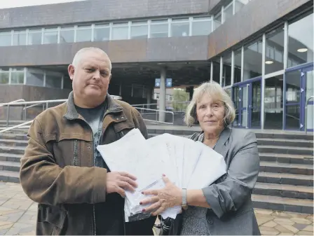  ??  ?? Penshaw residents Elaine Davidson and David Holyoak with the petition at Sunderland Civic Centre.