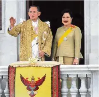  ?? — AFP ?? Beloved couple: Bhumibol and Sirikit waving to the crowd after an address in Bangkok in 2006.