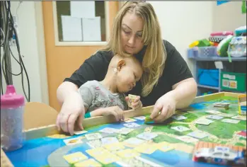  ?? NEWS-SENTINEL FILE PHOTOGRAPH ?? Tiffanie Quintero and daughter Mirella Quintero play games during a hospital stay as Mirella receives chemothera­py treatments in the oncology department at El Camino Hospital in Mountain View on Oct. 10, 2015. Mirella died on Sept. 4. “It’s something...