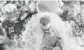  ?? DAVID GRUNFELD/AP ?? Tulane coach Willie Fritz gets doused after beating the Navy 29-28 Saturday to clinch bowl eligibilit­y.