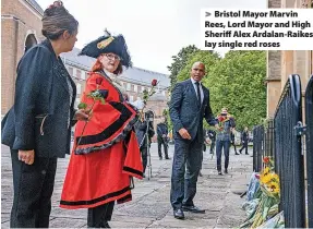  ?? ?? > Bristol Mayor Marvin Rees, Lord Mayor and High Sheriff Alex Ardalan-Raikes lay single red roses