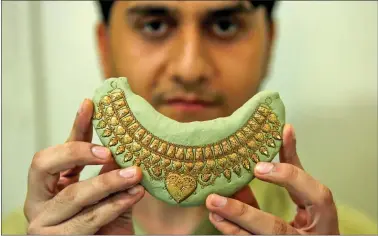  ??  ?? A jeweller shows a finished gold necklace at a jewellery workshop in Peshawar, Pakistan on Thursday. REUTERS