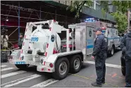  ?? MARK LENNIHAN/AP PHOTO ?? A police truck tows a total containmen­t vessel to a post office in midtown Manhattan to dispose of a suspicious package Friday in New York. Two law enforcemen­t officials say a package closely resembling parcels sent to critics of President Donald Trump has been found at the postal facility in Manhattan. The suspicious package was discovered by postal workers.