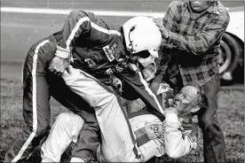  ?? RIC FELD / ASSOCIATED PRESS 1979 ?? Bobby Allison, left, grabs Cale Yarborough after a collision between Yarborough and Allison’s brother Donnie on the last lap of the Daytona 500 on Feb, 18, 1979. The wreck allowed Richard Petty to claim his sixth Daytona 500 win.
