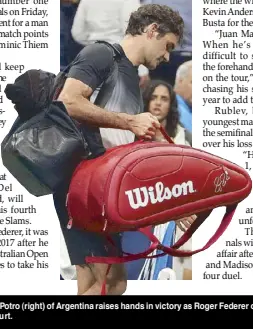  ?? AFP ?? Juan Martin del Potro (right) of Argentina raises hands in victory as Roger Federer of Switzerlan­d walks off the court.