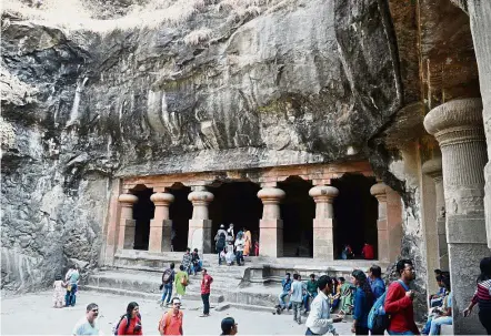  ?? — AFP ?? Living history: Tourists visiting temple caves on Elephanta Island near Mumbai. Elephanta only recently had electricit­y installed in houses for the first time.