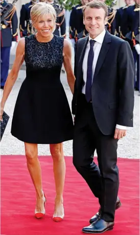  ??  ?? Petition: President Emmanuel Macron and his wife Brigitte