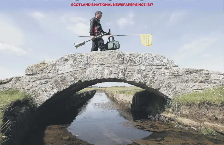  ?? PICTURE: ANDREW MILLIGAN/PA WIRE ?? 0 Greenkeepe­r Simon Connah crosses the Swilcan Bridge on the Old Course at St Andrews in Fife as final preparatio­ns are completed to the course ahead of reopening.