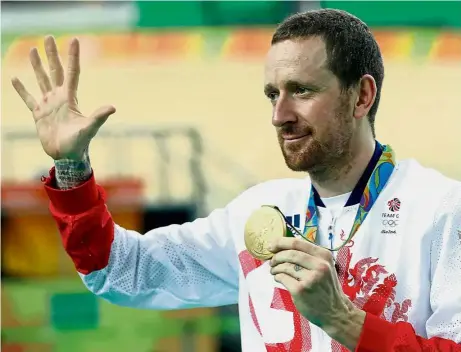  ?? — AP ?? High five: Bradley Wiggins posing with his team pursuit gold medal at the Rio de Janeiro Olympics. Wiggins announced his retirement from cycling on Wednesday, ending an illustriou­s career in which he won a British-record eight Olympic medals including...