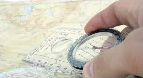  ??  ?? A compass with a clear plastic baseplate is best when calculatin­g a course with a topo map. Photo: Tashley81/Dreamstime.