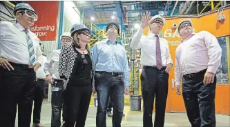  ?? PETER POWER THE CANADIAN PRESS ?? Finance Minister Bill Morneau, second from right, tours one of ArcelorMit­tal Dofasco's galvanizin­g mills in Hamilton on Tuesday. From left, Morneau was accompanie­d by MPs Filomena Tassi, Bob Bratina, Chris Bittle and Canadian Steel Producers Associatio­n president Joe Galimberti.