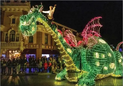  ?? LEONARD ORTIZ — STAFF PHOTOGRAPH­ER ?? 3
An Elliot the Dragon float is part of Disneyland’s Main Street Electrical Parade, shown in April during its latest revival. The attraction, a stalwart for more than 50years, consistent­ly goes on hiatus, then returns whenever the Anaheim theme park seems to need an attendance boost.