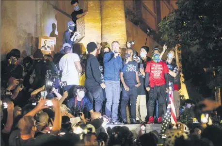  ?? NOAH BERGER — THE ASSOCIATED PRESS ?? Portland Mayor Ted Wheeler speaks to Black Lives Matter protesters on Wednesday, July 22, 2020, in Portland, Ore.